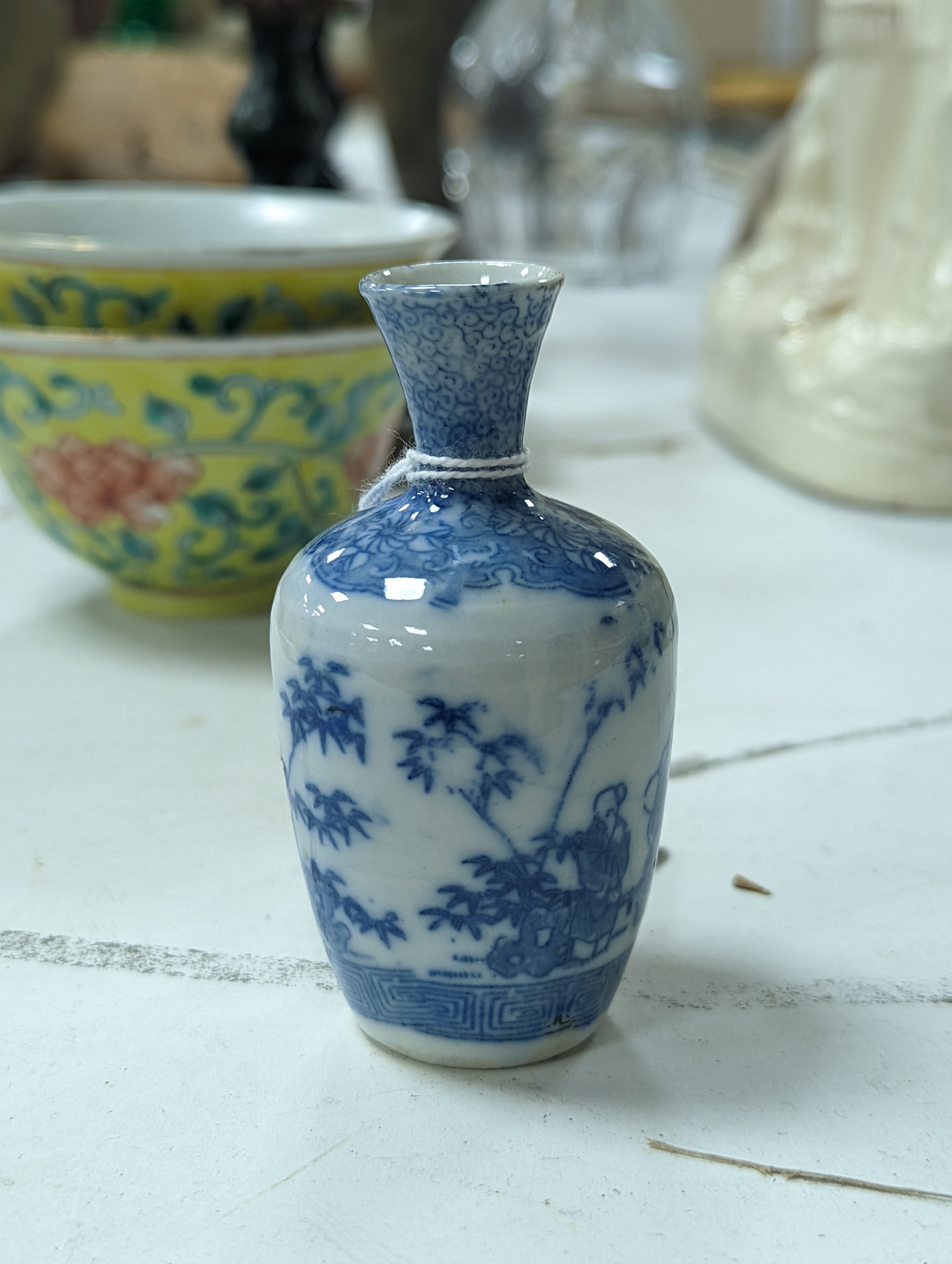 A group of Chinese porcelain, 19th /20th century, to include a pair of yellow ground bowls, 10.8 cm diameter, a blue and white vase, Xuande mark, a similar bowl and vase, and a champleve enamel bronze koro and cover